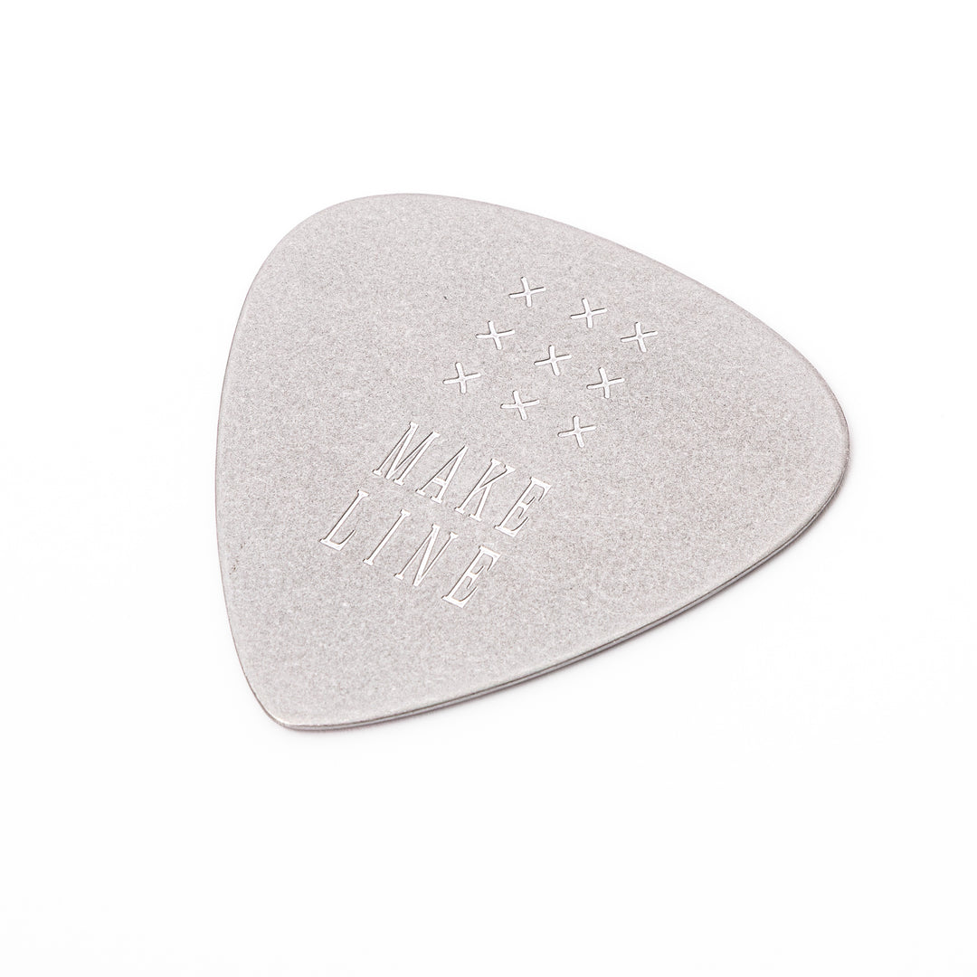Unique guitar pick shaped metal coaster with vintage matte finish engraved with make line text and cross patterns