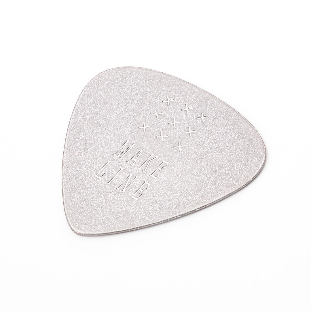 Unique guitar pick shaped metal coaster with sandblasted textured finish engraved with make line text and cross patterns