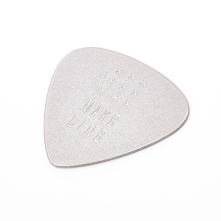 Unique guitar pick shaped metal coaster with sandblasted textured finish engraved with make line text and cross patterns