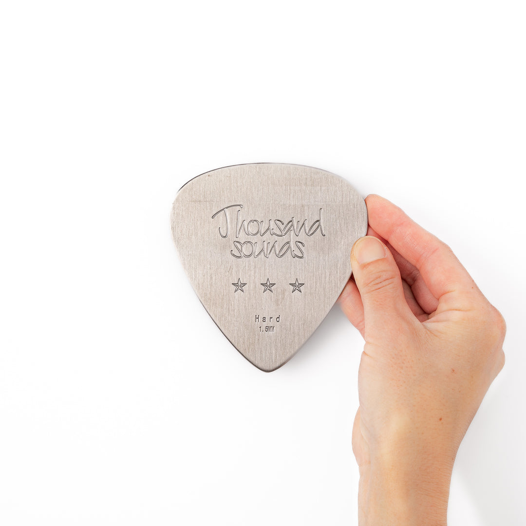 Unique guitar pick shaped stainless steel metal coaster engraved with thousand sounds text and stars