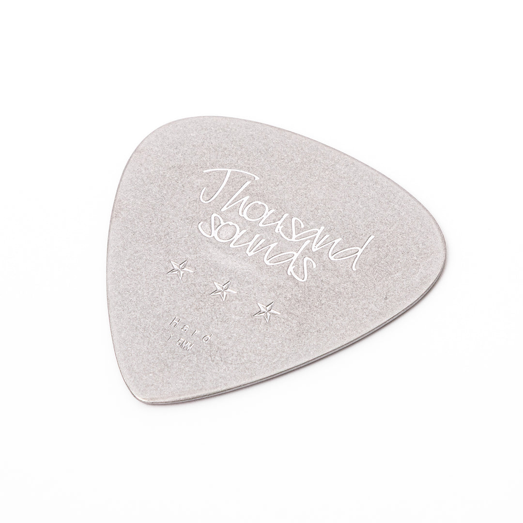 Unique guitar pick shaped metal coaster with vintage matte finish engraved with thousand sounds text and stars
