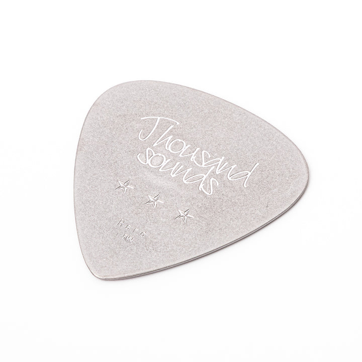 Unique guitar pick shaped metal coaster with vintage matte finish engraved with thousand sounds text and stars