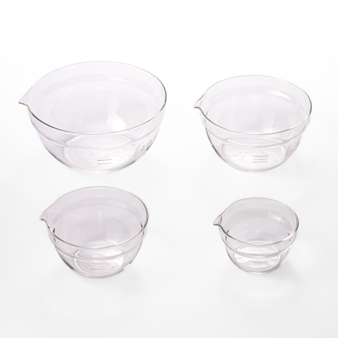 Set of four HARIO heat resistant glass mixing bowls with pour spouts, featuring various nested sizes for easy meal prep