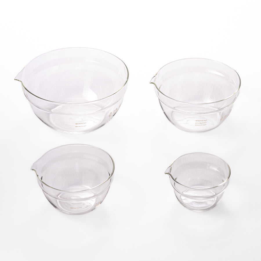 Set of four HARIO heat resistant glass mixing bowls with pour spouts, featuring various nested sizes for easy meal prep