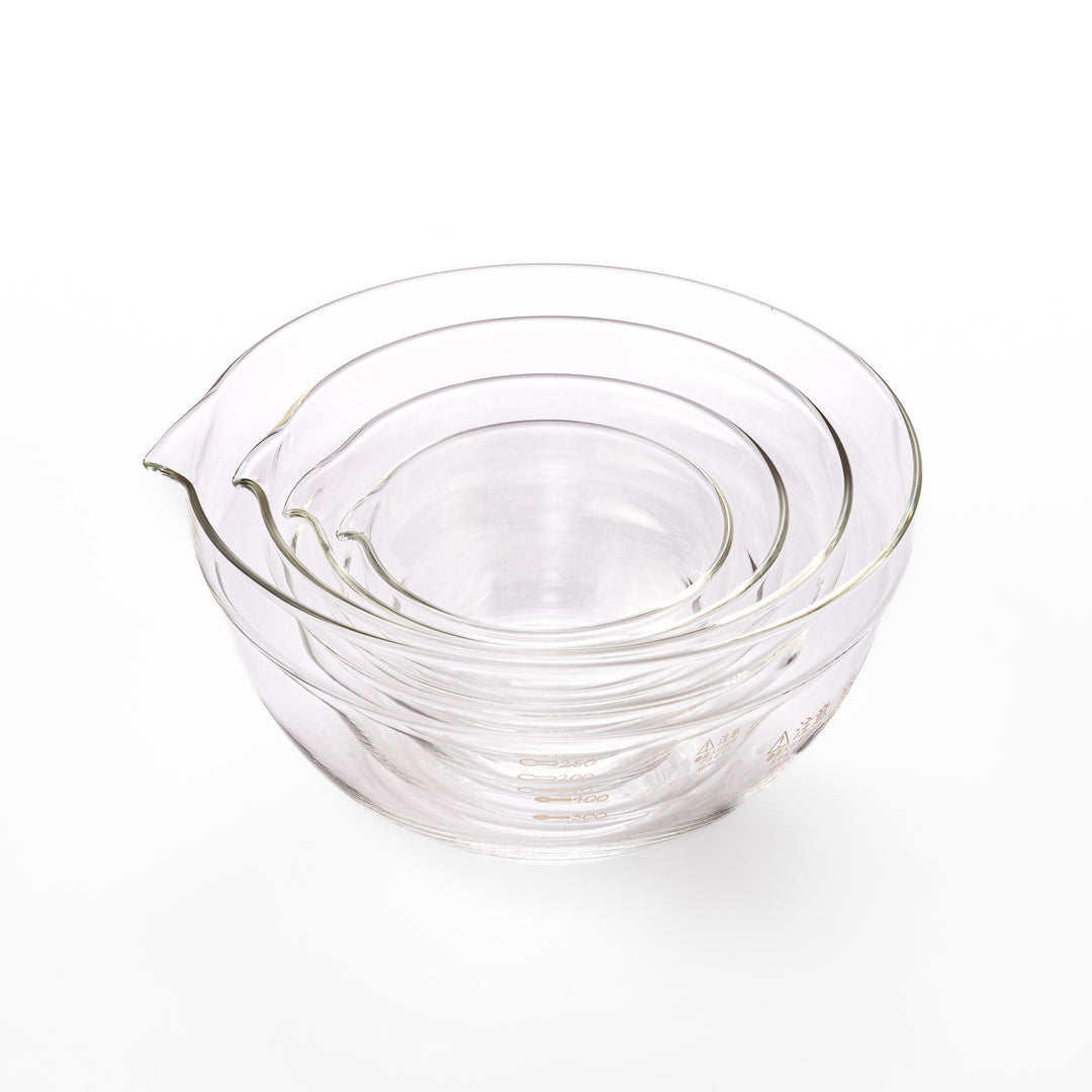 Set of four HARIO heat resistant glass mixing bowls with pour spouts, featuring various nested sizes for easy meal prep