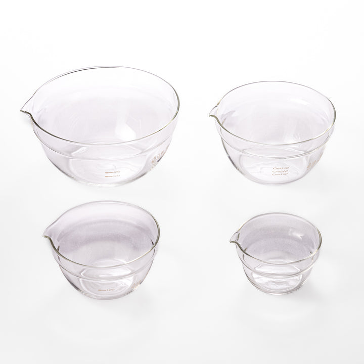 Set of four HARIO heat resistant glass mixing bowls with pour spouts, featuring various nested sizes for easy meal prep