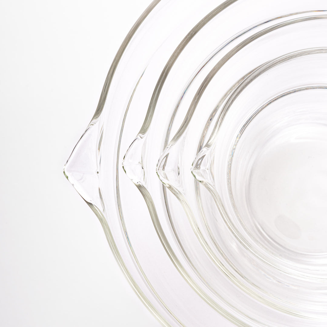 Set of four HARIO heat resistant glass mixing bowls with pour spouts, featuring various nested sizes for easy meal prep