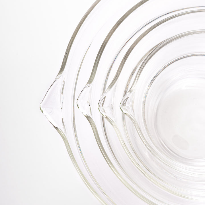 Set of four HARIO heat resistant glass mixing bowls with pour spouts, featuring various nested sizes for easy meal prep