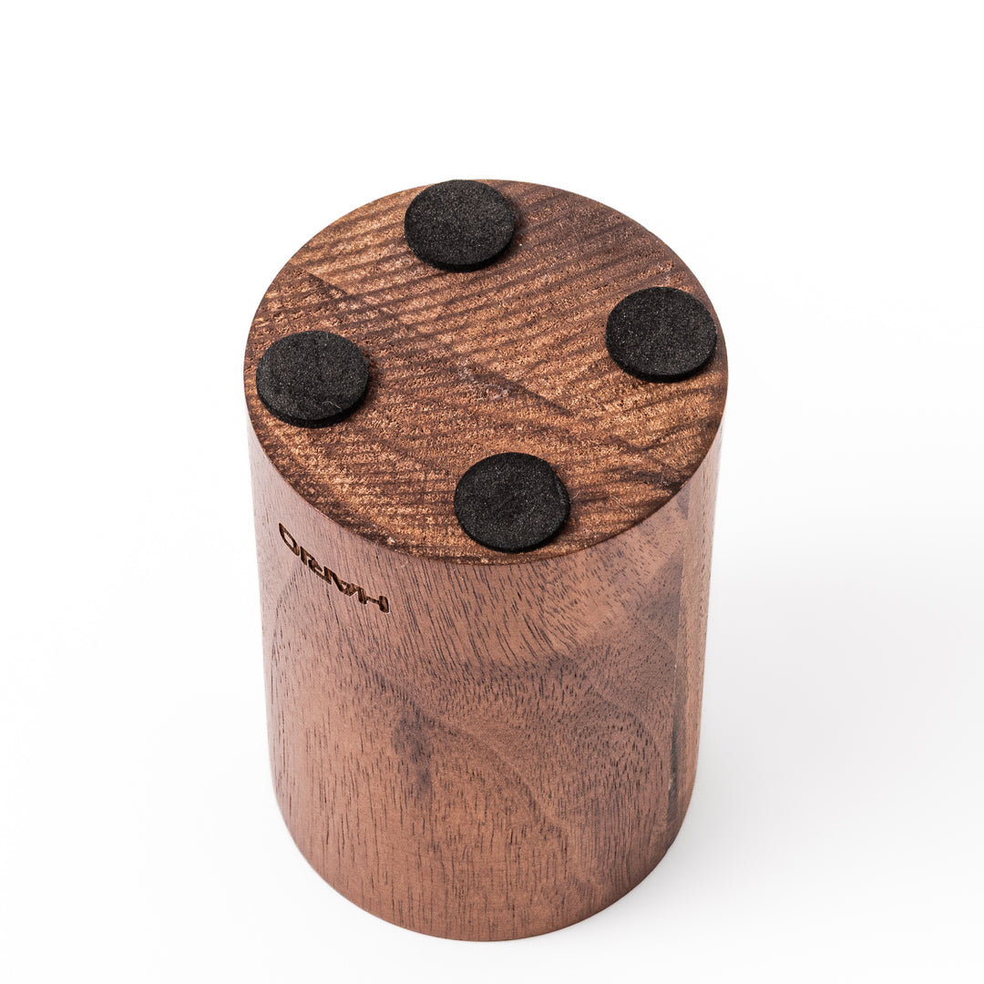 HARIO walnut wood manual coffee grinder with a hand crank, featuring a sleek natural wooden body on a white background