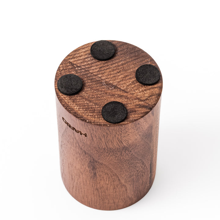 HARIO walnut wood manual coffee grinder with a hand crank, featuring a sleek natural wooden body on a white background