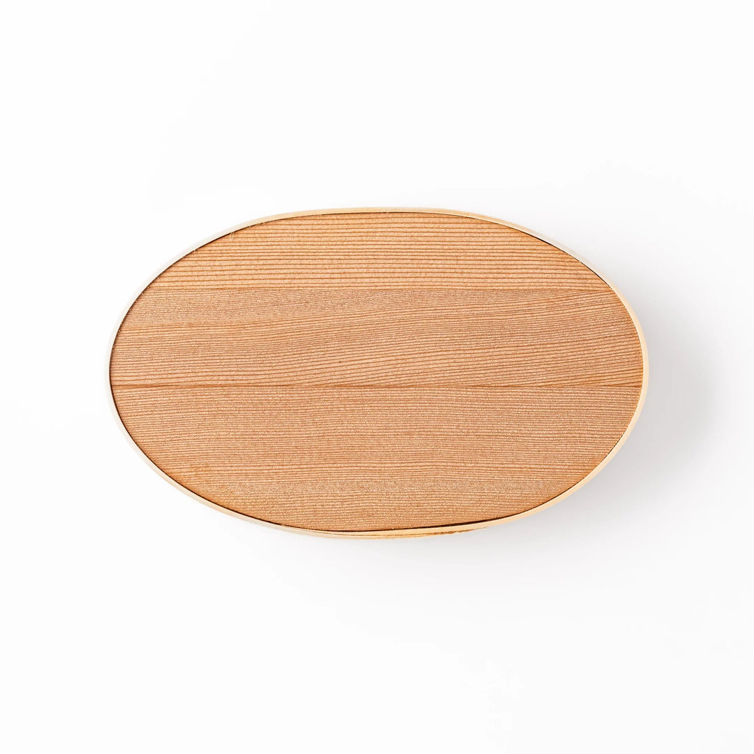 Oval bento box handcrafted from smooth hinoki wood with traditional joinery, offering a lightweight and aromatic way to carry Japanese-style meals.
