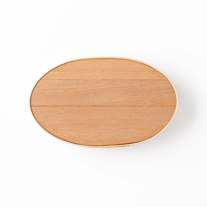 Oval bento box handcrafted from smooth hinoki wood with traditional joinery, offering a lightweight and aromatic way to carry Japanese-style meals.
