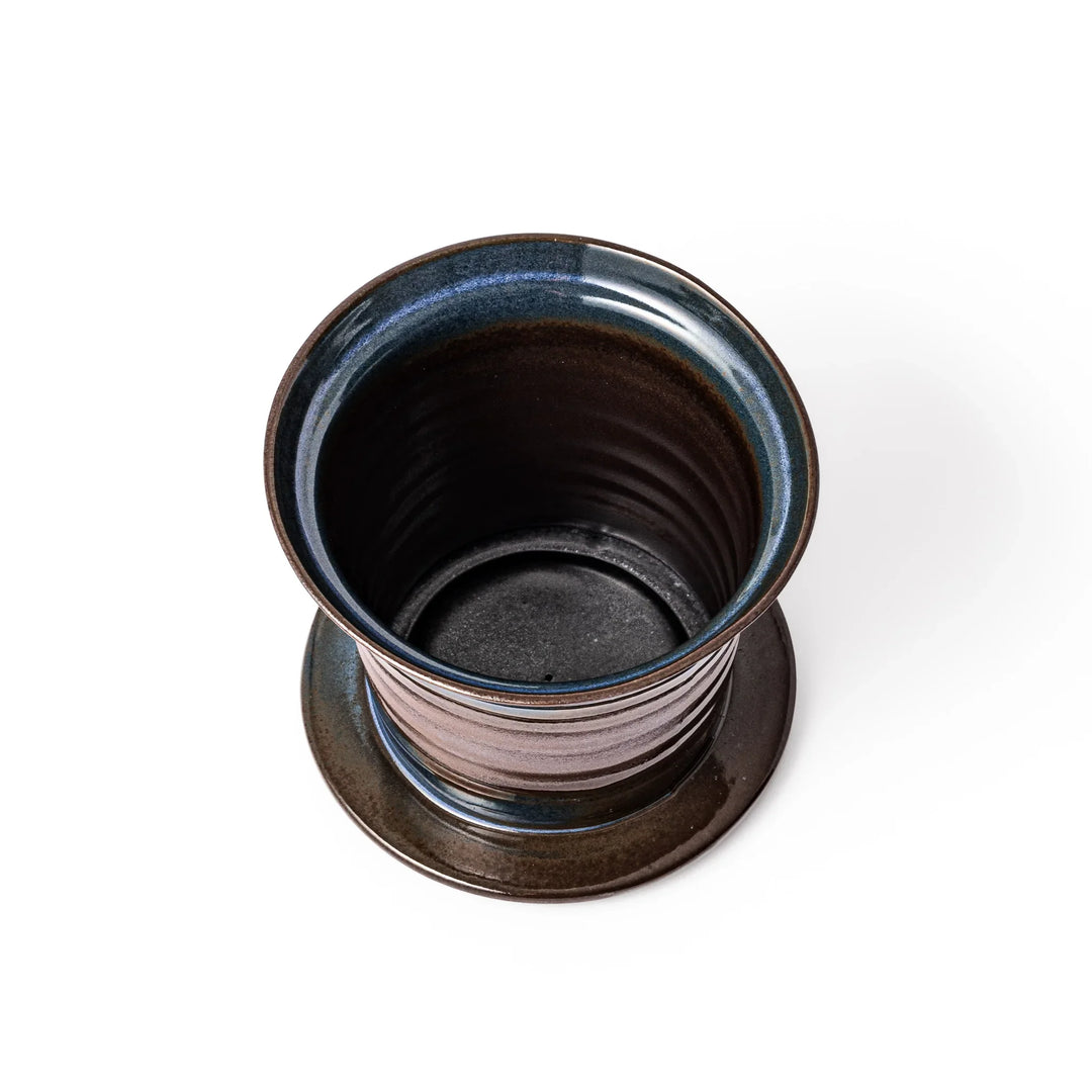Handcrafted ceramic coffee dripper in earthy brown and blue glaze with detachable fine mesh filter, designed for single-serve brewing.