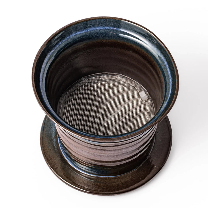 Handcrafted ceramic coffee dripper in earthy brown and blue glaze with detachable fine mesh filter, designed for single-serve brewing.