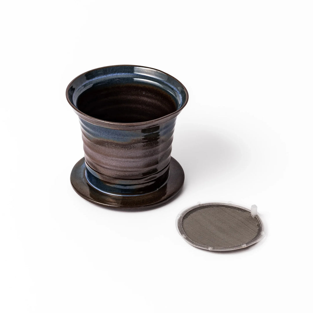 Handcrafted ceramic coffee dripper in earthy brown and blue glaze with detachable fine mesh filter, designed for single-serve brewing.