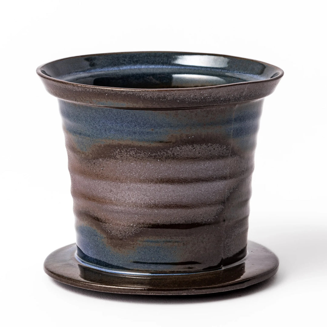 Handcrafted ceramic coffee dripper in earthy brown and blue glaze with detachable fine mesh filter, designed for single-serve brewing.