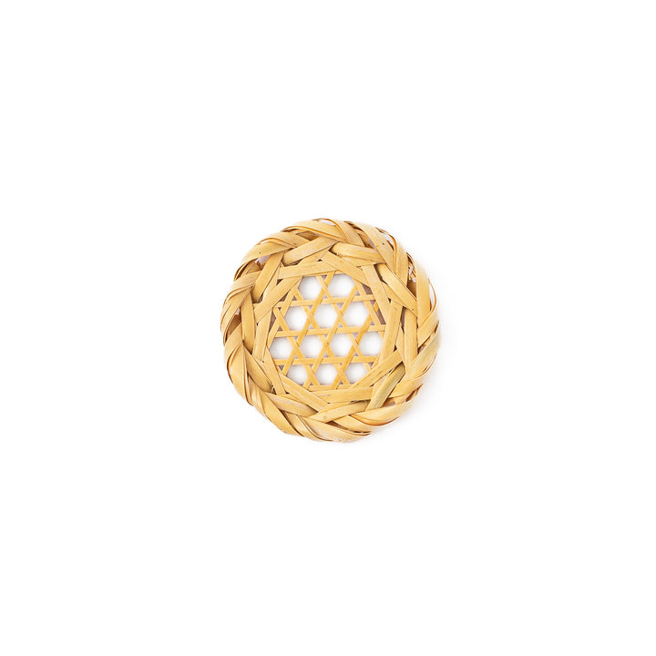 A round handwoven bamboo drink coaster showcasing a traditional star pattern weave and a braided natural fiber border