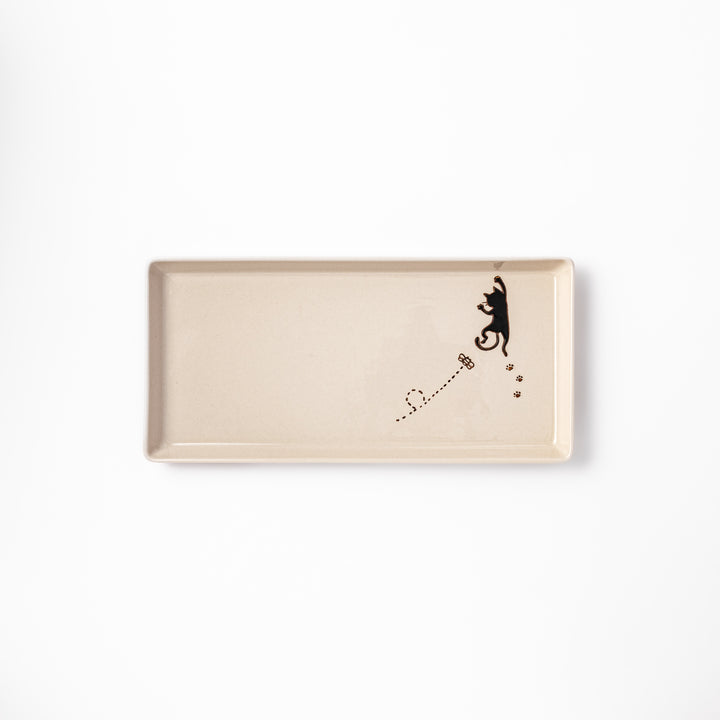 Beige rectangular ceramic plate featuring a playful black cat illustration with paw prints and a butterfly in the corner.