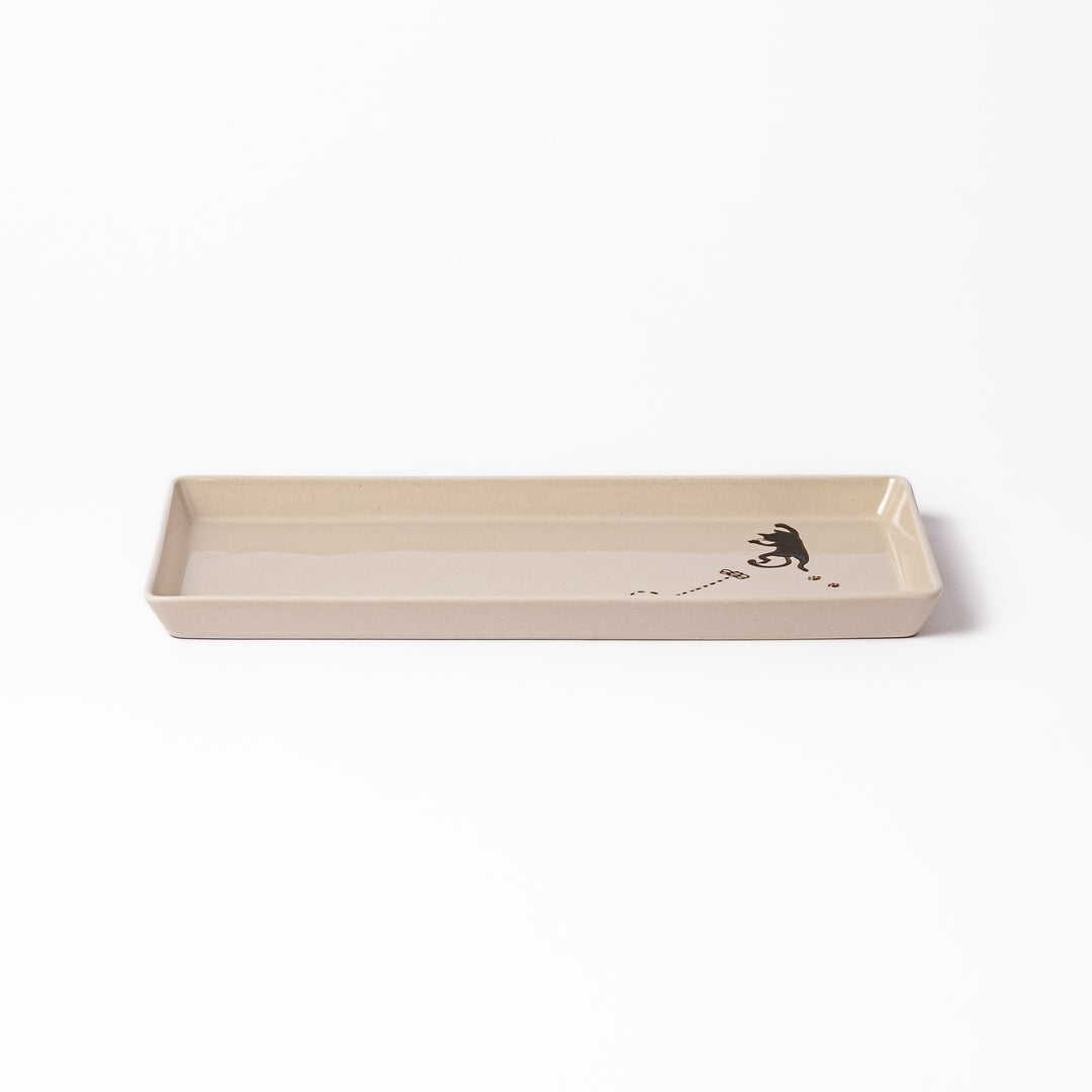 Beige rectangular ceramic plate featuring a playful black cat illustration with paw prints and a butterfly in the corner.