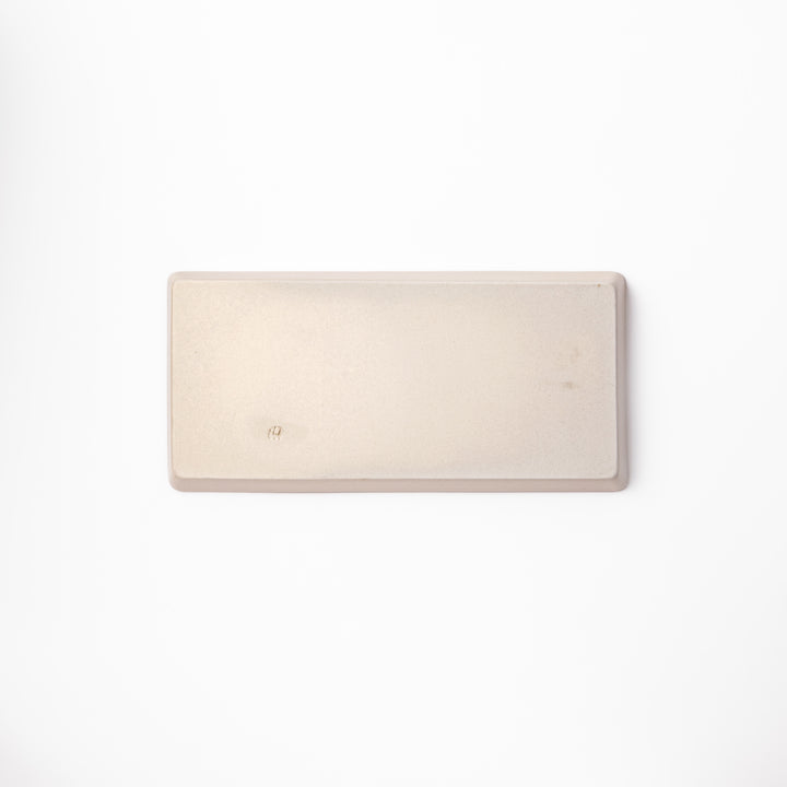 Beige rectangular ceramic plate featuring a playful black cat illustration with paw prints and a butterfly in the corner.