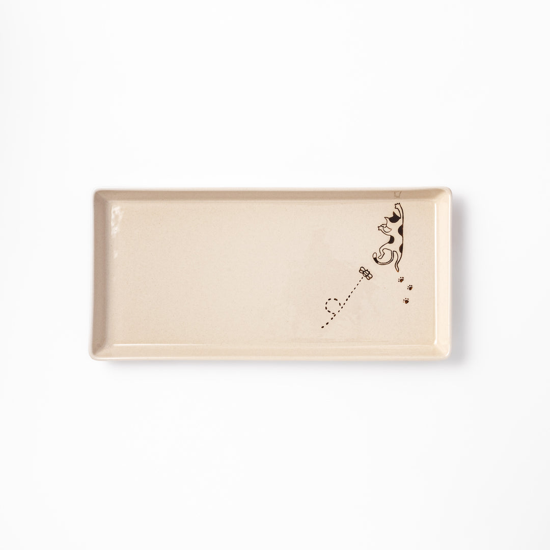Beige rectangular ceramic plate featuring a playful calico cat illustration with paw prints and a butterfly in the corner.
