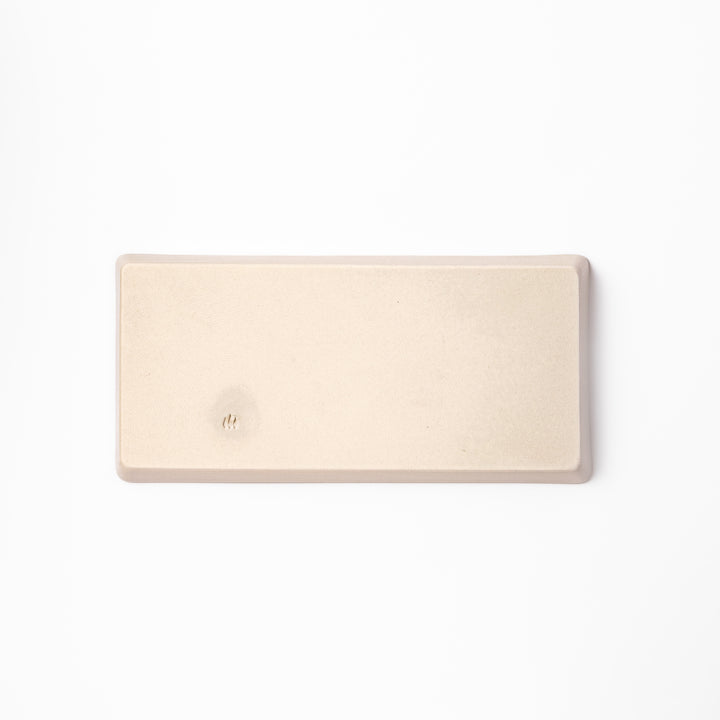 Beige rectangular ceramic plate featuring a playful calico cat illustration with paw prints and a butterfly in the corner.