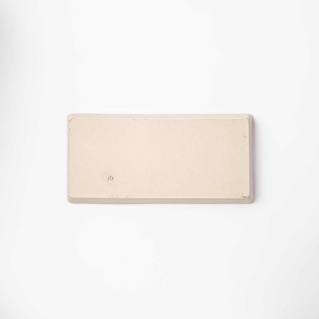 Beige rectangular ceramic plate featuring a playful tabby cat illustration with paw prints and a butterfly in the corner.