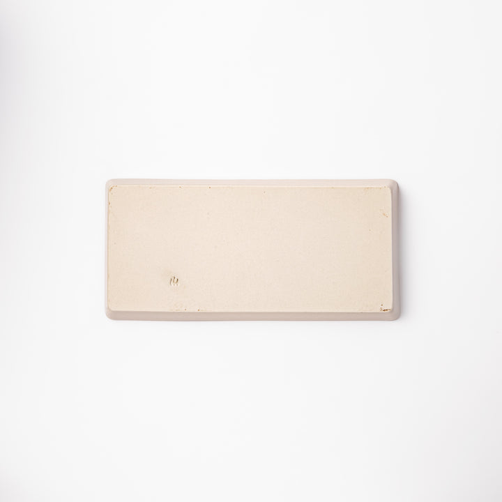 Beige rectangular ceramic plate featuring a playful tabby cat illustration with paw prints and a butterfly in the corner.
