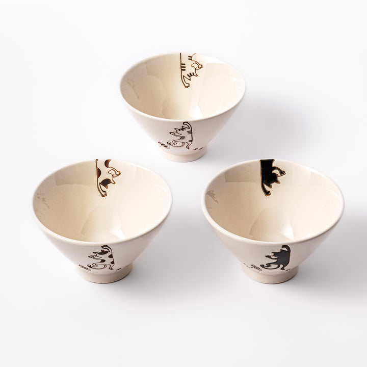 Set of three cream-colored rice bowls with hanging cat designs in black, calico, and tabby, featuring butterflies and paw prints.
