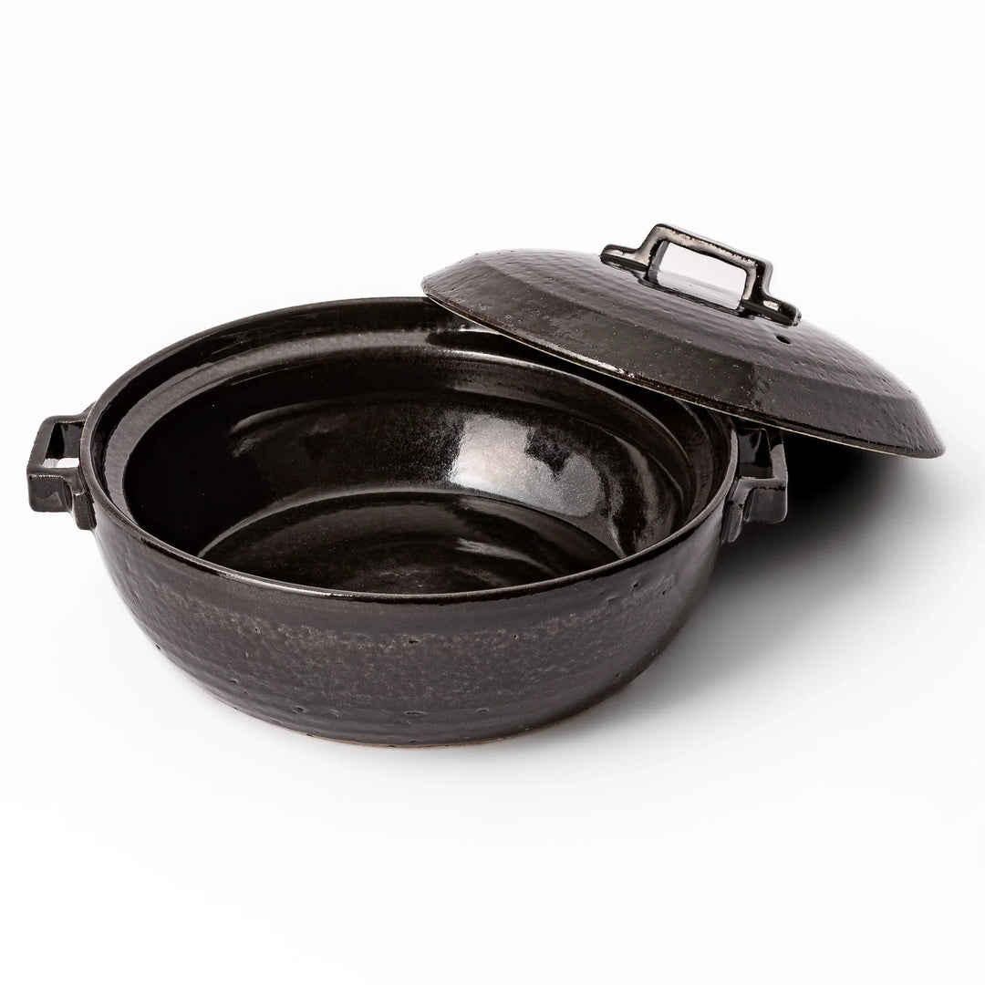 Black Japanese ceramic donabe with a fitted lid and side handles for family size hot pot and stovetop cooking