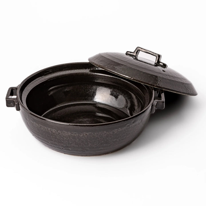 Black Japanese ceramic donabe with a fitted lid and side handles for family size hot pot and stovetop cooking