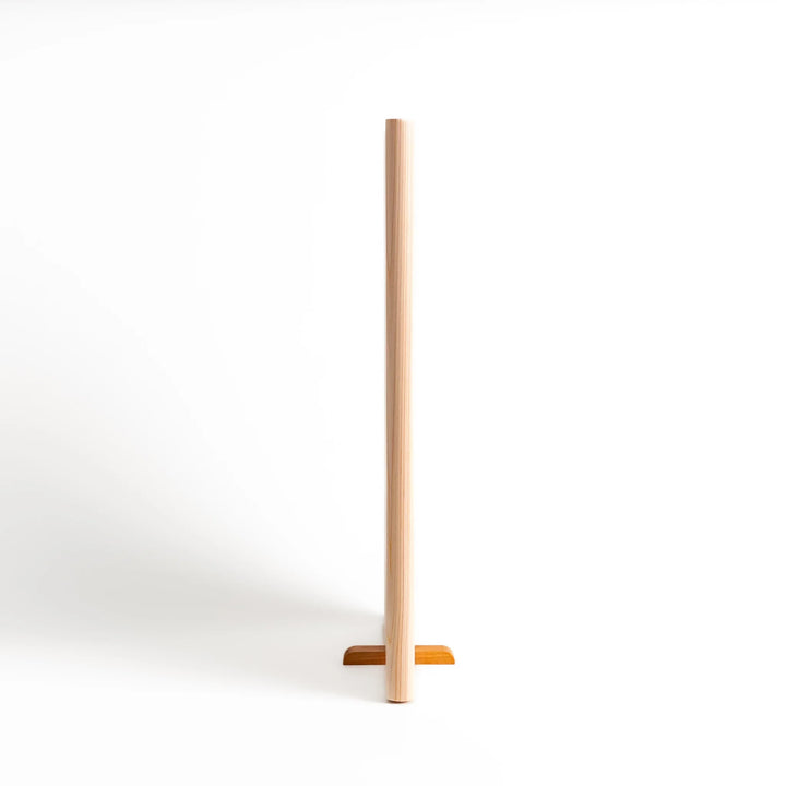 Hinoki wood cutting board with a built-in stand and engraved corner logo, showcasing natural grain and ideal for clean, stylish prep work.

