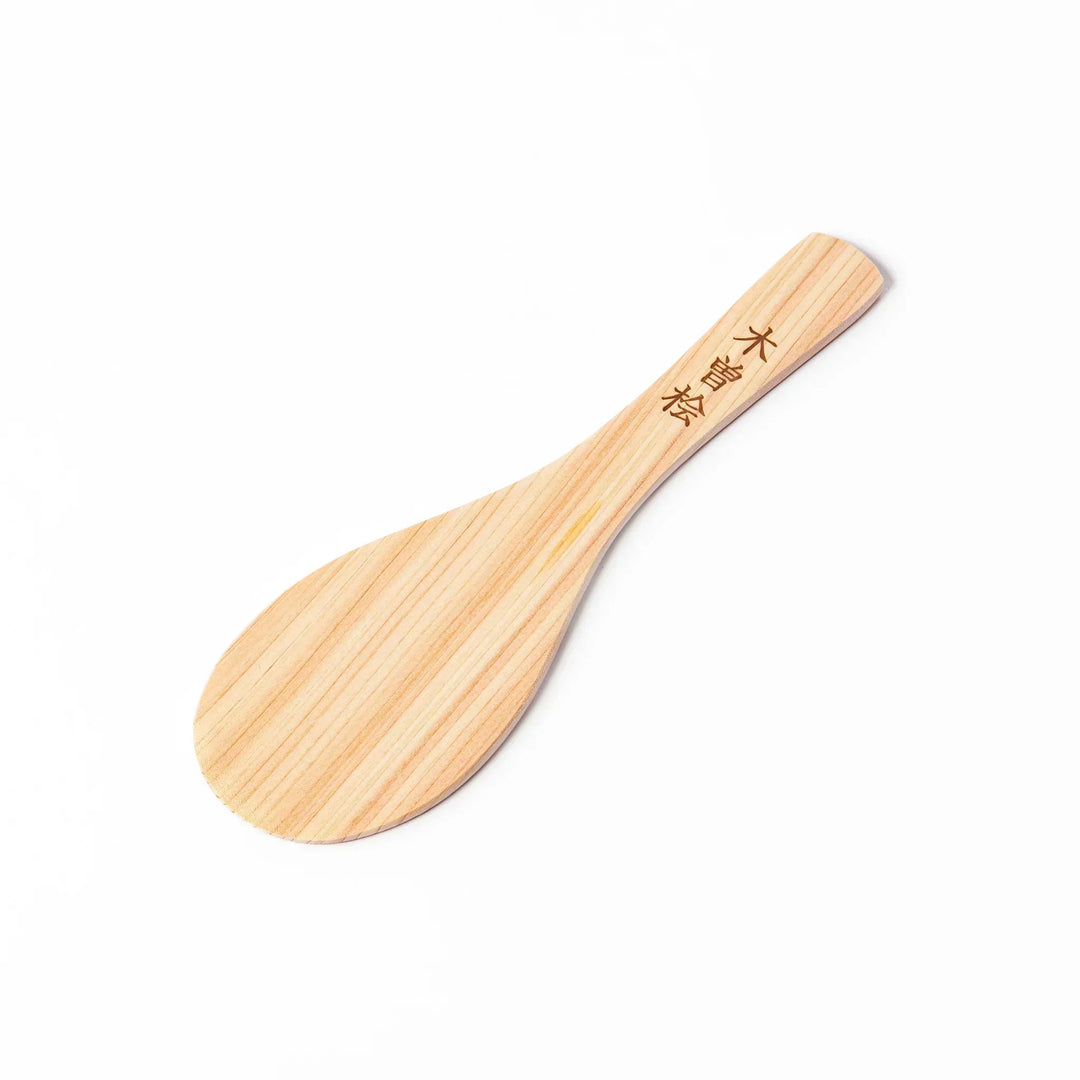 Japanese hinoki wood rice paddle with natural grain and engraved characters, lightweight and smooth for serving cooked rice