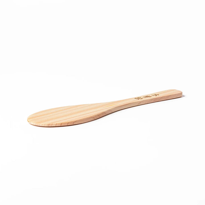 Japanese hinoki wood rice paddle with natural grain and engraved characters, lightweight and smooth for serving cooked rice