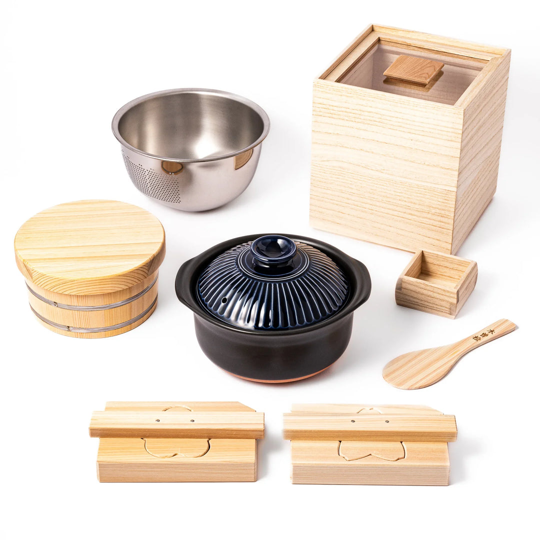 Complete Japanese rice set with ceramic donabe, stainless steel bowl, wooden rice container, hinoki paddle, and serving tools