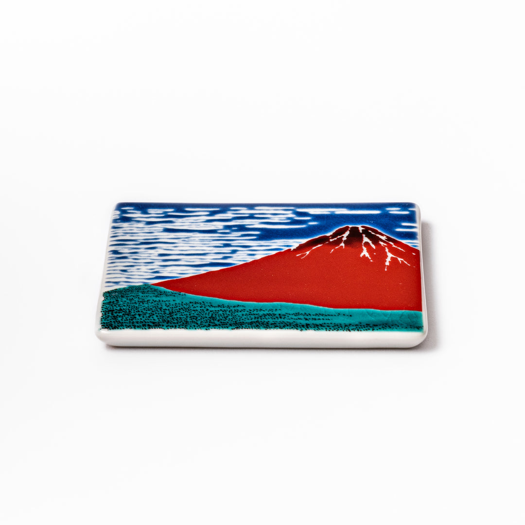 Square Japanese ceramic coaster featuring Hokusai’s Red Fuji design with vivid red mountain, blue sky, and clouds, adding iconic artistry to dining tables.
