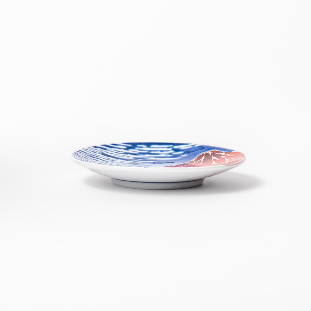 Round Japanese ceramic sauce dish featuring Hokusai’s iconic Red Fuji design with vivid red mountain, blue sky, and clouds, perfect for soy sauce or condiments.