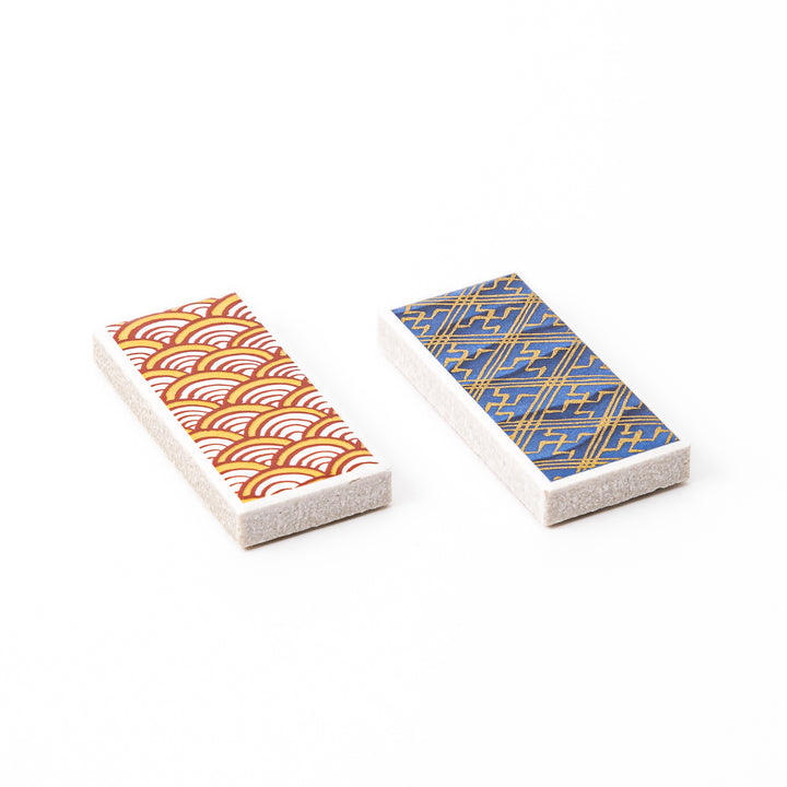 Two rectangular ceramic chopstick rests decorated with yellow wave and blue geometric traditional Japanese patterns