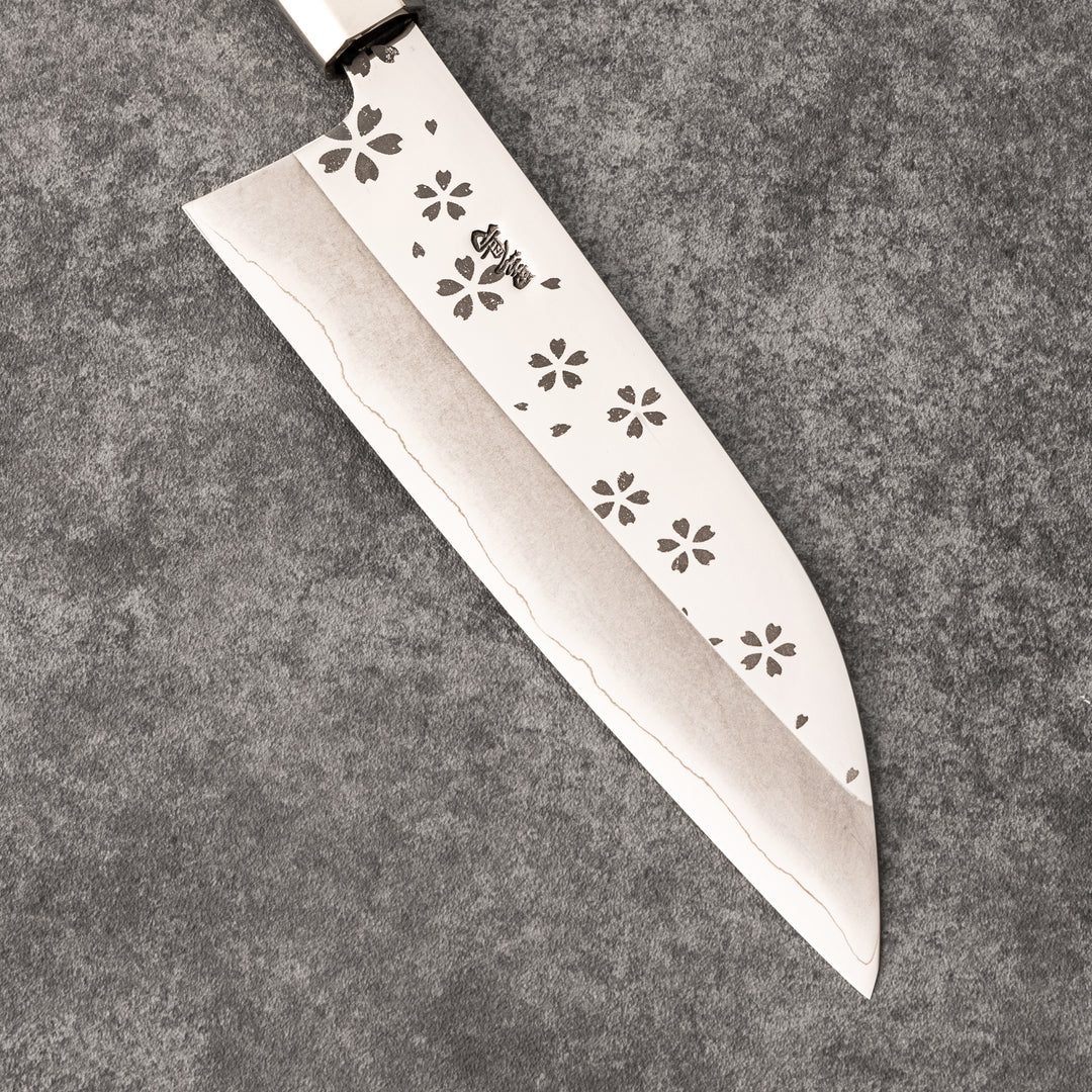 Elegant Japanese kitchen knife with cherry blossom cutout pattern on the blade, featuring a sharp edge and dark wooden handle for precise cutting.