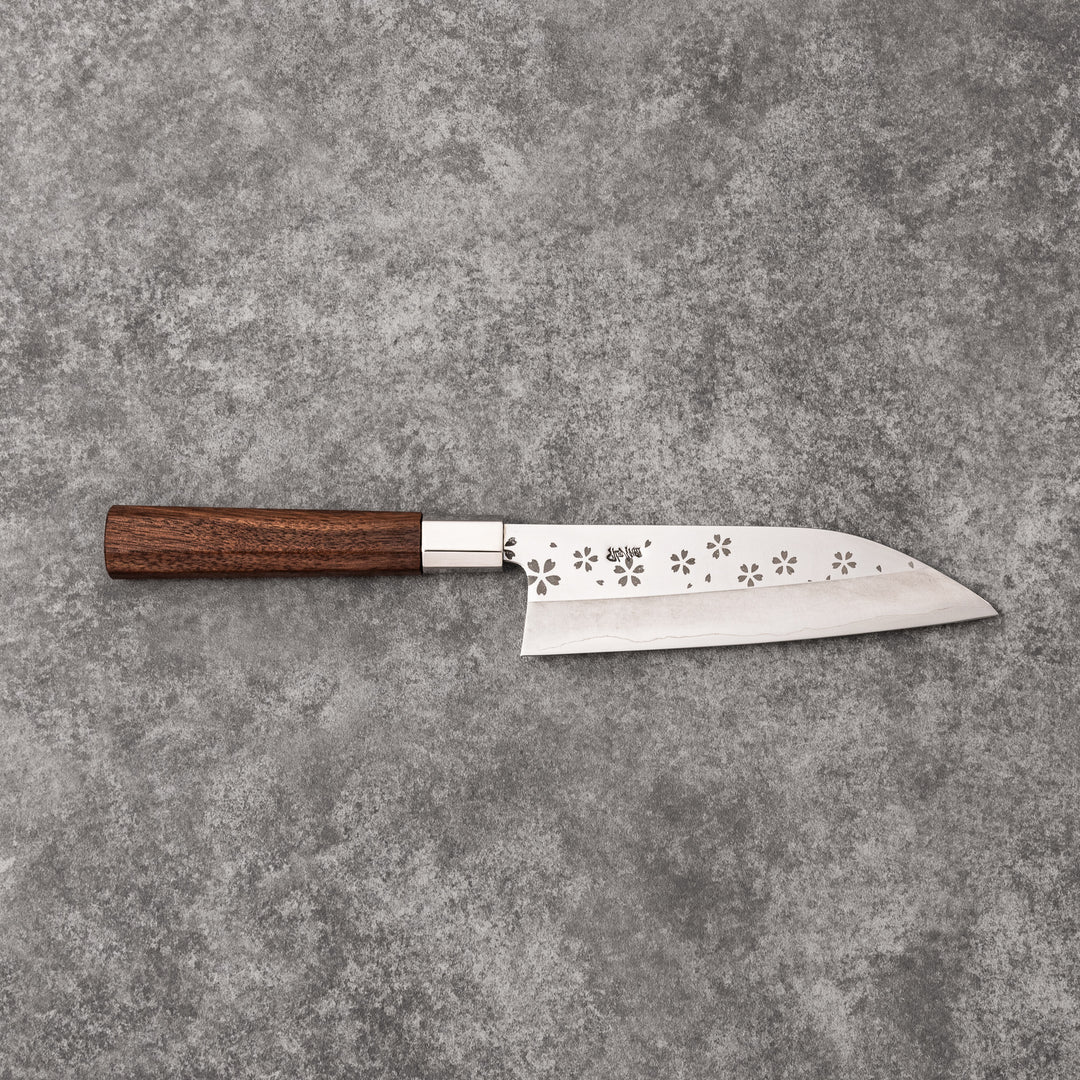 Elegant Japanese kitchen knife with cherry blossom cutout pattern on the blade, featuring a sharp edge and dark wooden handle for precise cutting.