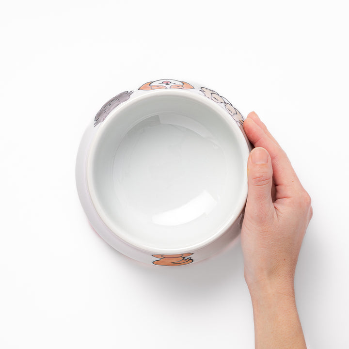 Japanese ceramic dog bowl with hand painted dog face designs and raised rim for pets