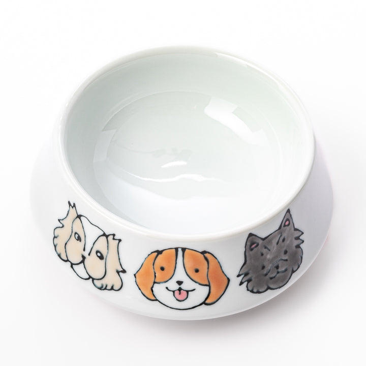 Japanese ceramic dog bowl with hand painted dog face designs and raised rim for pets