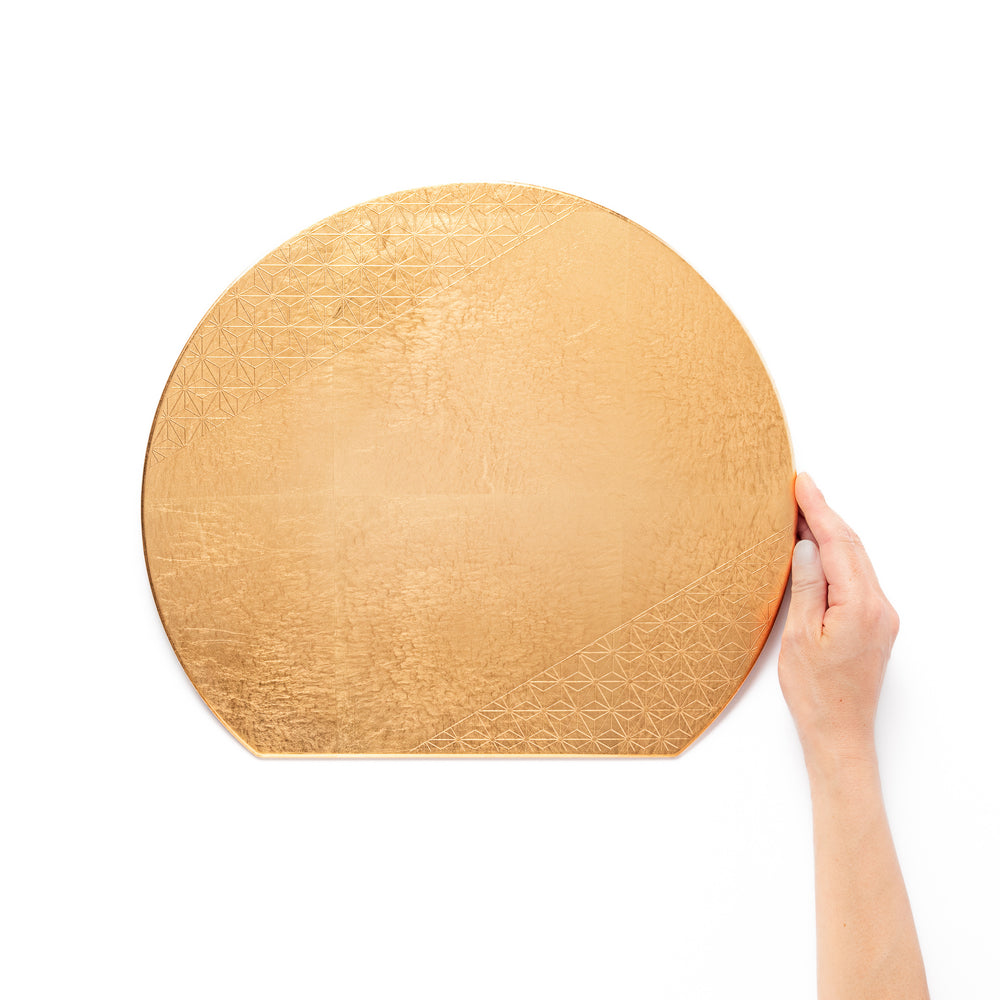 Gold Japanese Asanoha Hemp Leaf Placemat with a semi-circular shape and embossed pattern, ideal for elegant table settings and refined seasonal presentation.