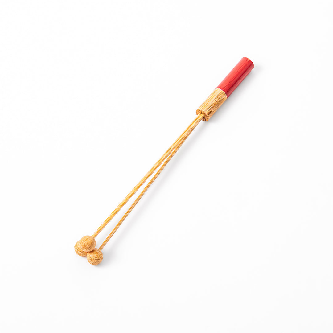 Single Japanese bamboo drink stirrer featuring a red handle top and wooden bead tips for mixing cocktails or tea