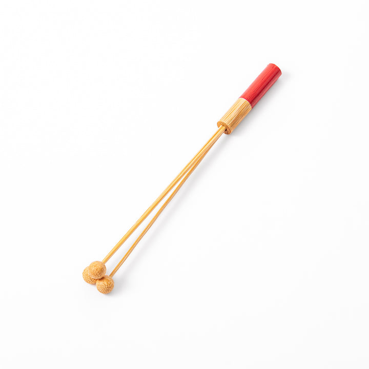 Single Japanese bamboo drink stirrer featuring a red handle top and wooden bead tips for mixing cocktails or tea
