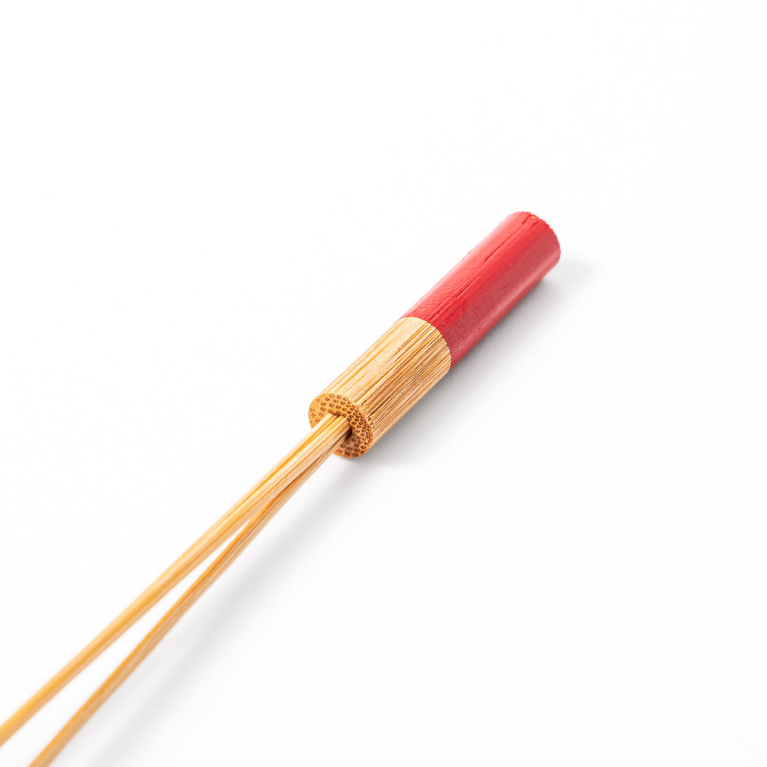 Single Japanese bamboo drink stirrer featuring a red handle top and wooden bead tips for mixing cocktails or tea