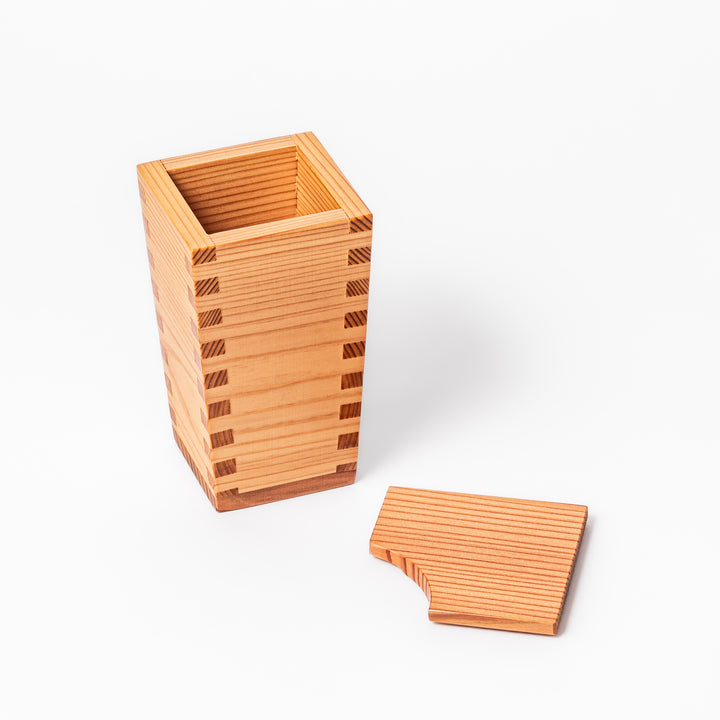 Japanese cedar sake carafe with square lid and visible joinery, combining natural wood texture with traditional craftsmanship for authentic sake service.