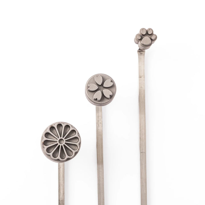 Assorted Japanese bread branding iron stamps with chrysanthemum, sakura, and paw print designs for decorating sweets and cakes
