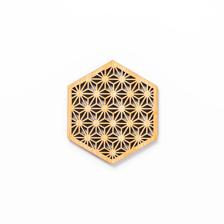 Hinoki wood coaster with a detailed hemp star cutout pattern in a hexagon shape against a white background.