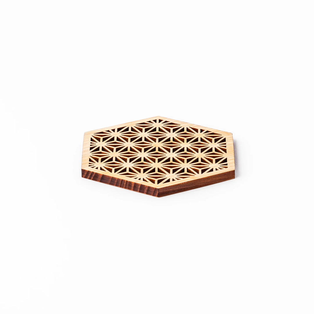 Hinoki wood coaster with a detailed hemp star cutout pattern in a hexagon shape against a white background.